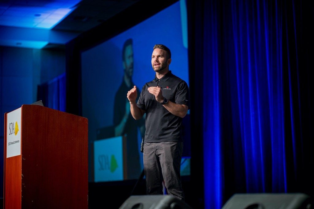 Mac Clemmens speaking on stage at a special districts conference.